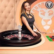 Live roulette: professional studio production Live roulette wheel spin captured on HD camera with dealer hand visible